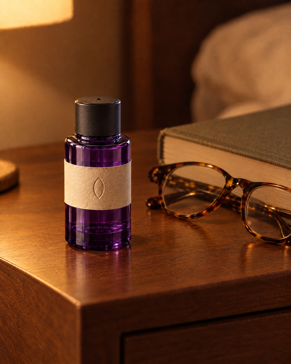 The eye bottle on a bedside table beside reading glasses and a book
