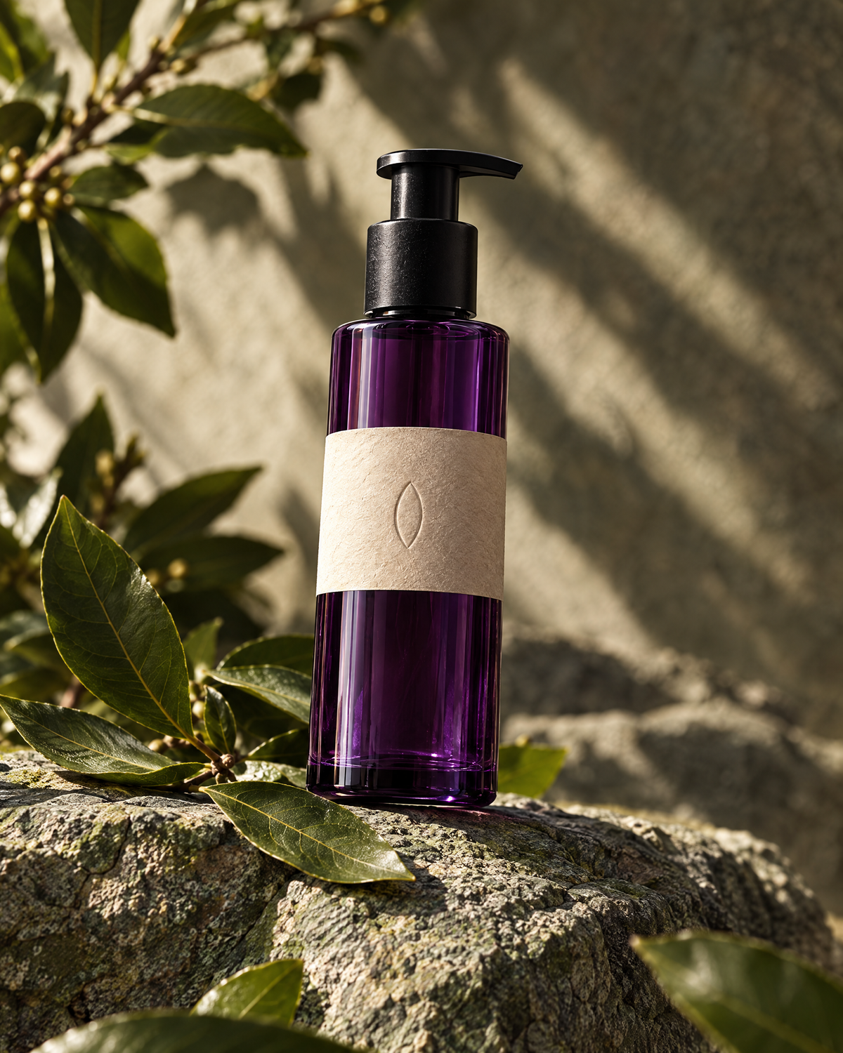 The laurel tonic on green-grey stone in hard sun, fresh laurel leaves around it